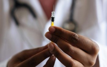 close-up of doctor hands holding syringe with needle