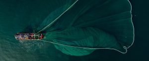 fishing boat pulling net view from above