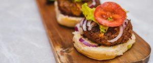 open-faced vegan burger on wooden board