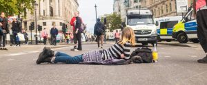 person lying down in road protest