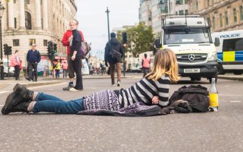person lying down in road protest