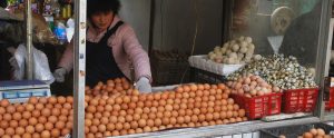person selling eggs from market stall China