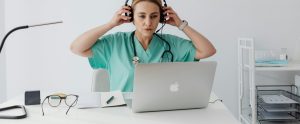 doctor sitting at laptop virtual medical care