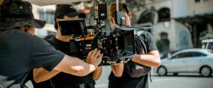 person holding camera movie set