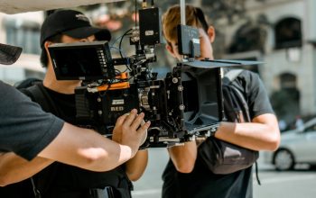 person holding camera movie set