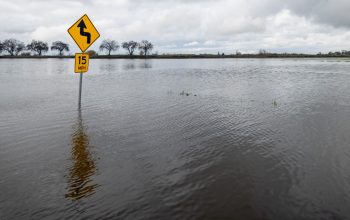 traffic sign submerged in flood waters