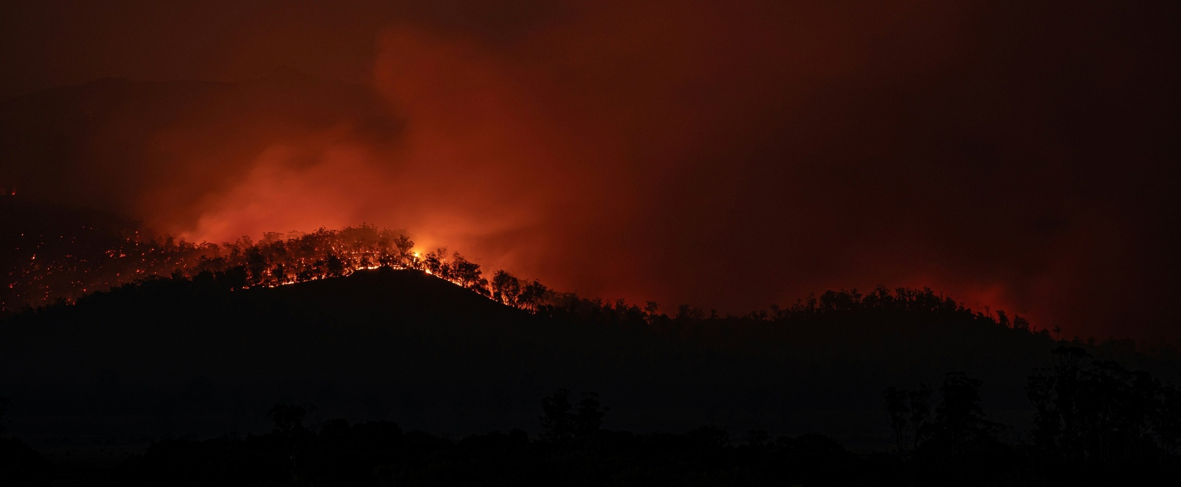 bushfire on hill at nighttime Tasmania Australia