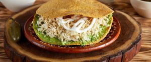 chicken tostada on wooden board
