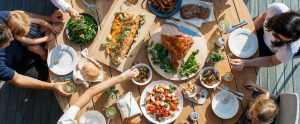people eating meal together outdoors view of table from above