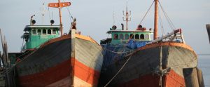two fishing boats moored side by side