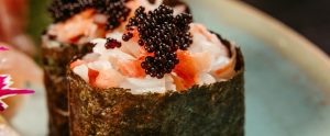 close-up of sushi roll with caviar