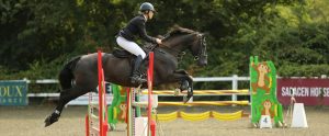 person competing in horse showjumping event Gloucester United Kingdom