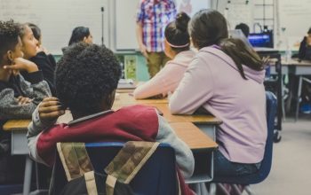 classroom of students listening to teacher