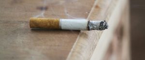 cigarette on its side smoldering
