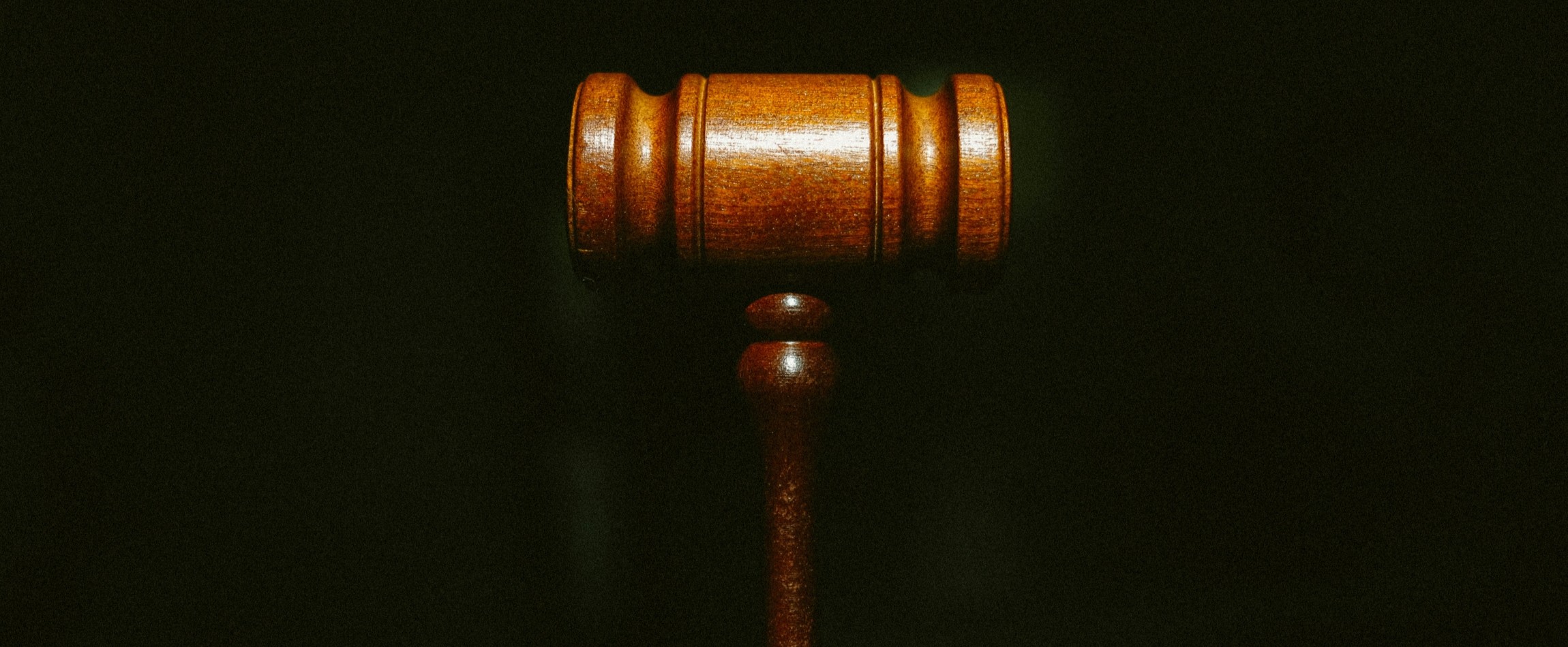 close-up of wooden gavel dark background