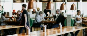empty table with blurred people eating in background cafe