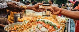 hands exchanging money for food street market India