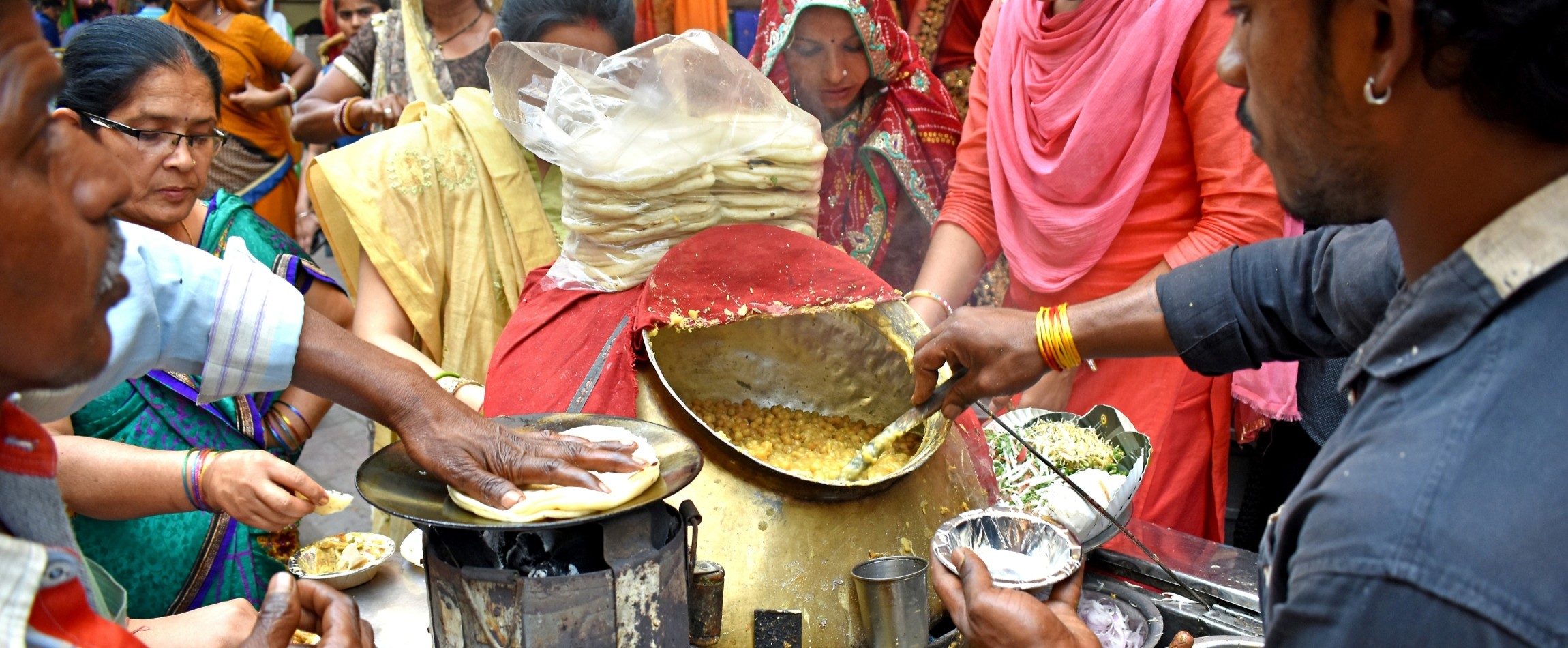 people crowded around street food vendor Chandni Chowk market India