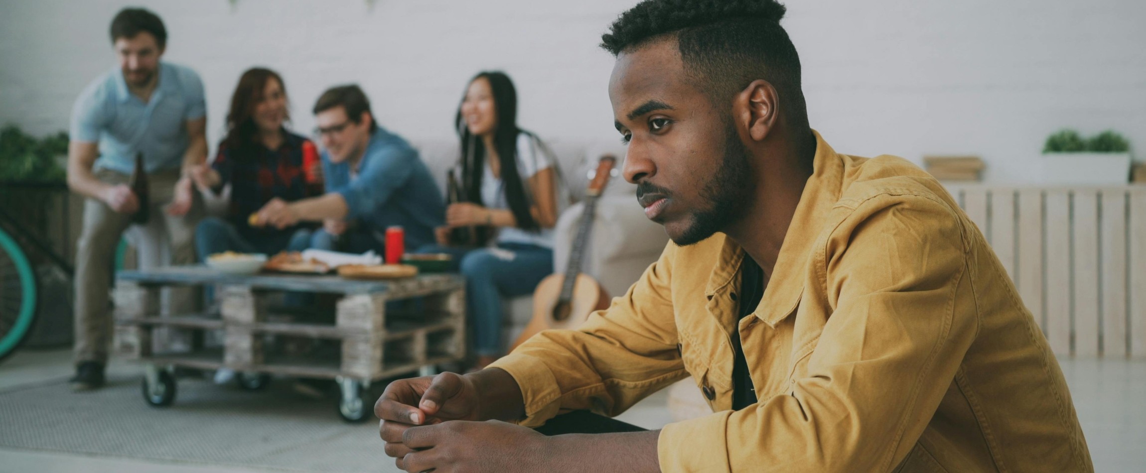 person feeling left out while friends eat in background
