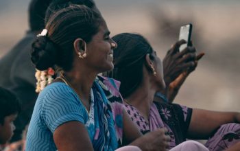 family sitting together on beach Puducherry India