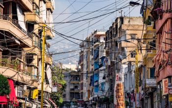 cables hanging between colourful buildings Beirut Lebanon