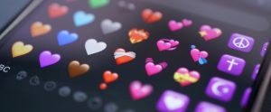 close-up of heart emojis on phone screen