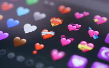 close-up of heart emojis on phone screen