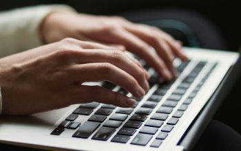 hands typing on laptop