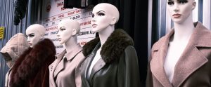 row of mannequins wearing fur-trimmed coats