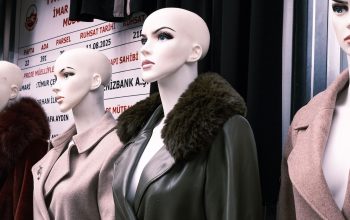 row of mannequins wearing fur-trimmed coats