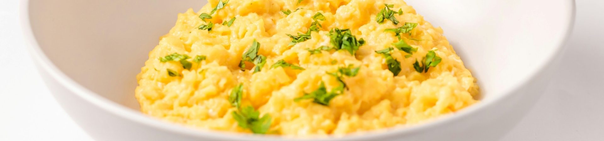 white bowl of scrambled eggs