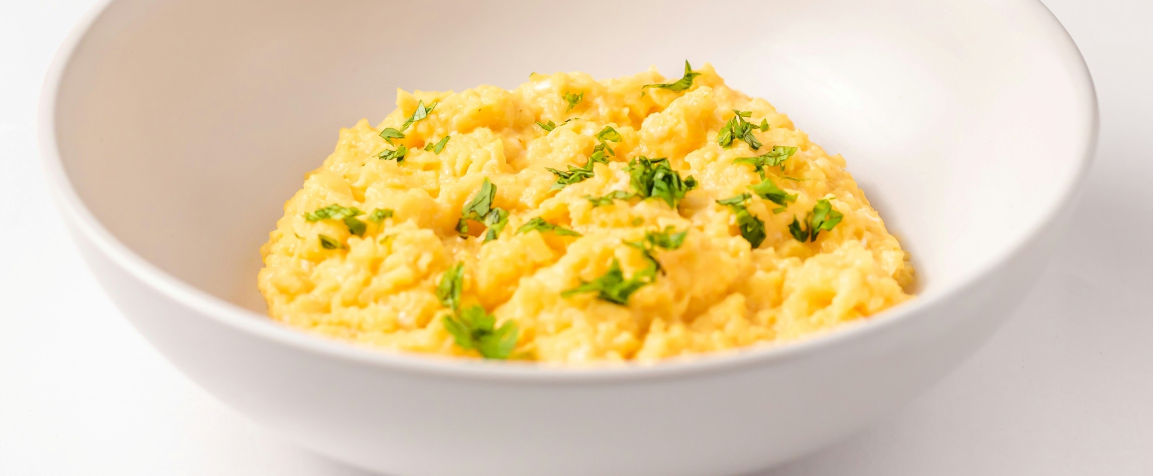 white bowl of scrambled eggs