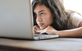 woman staring intently at laptop