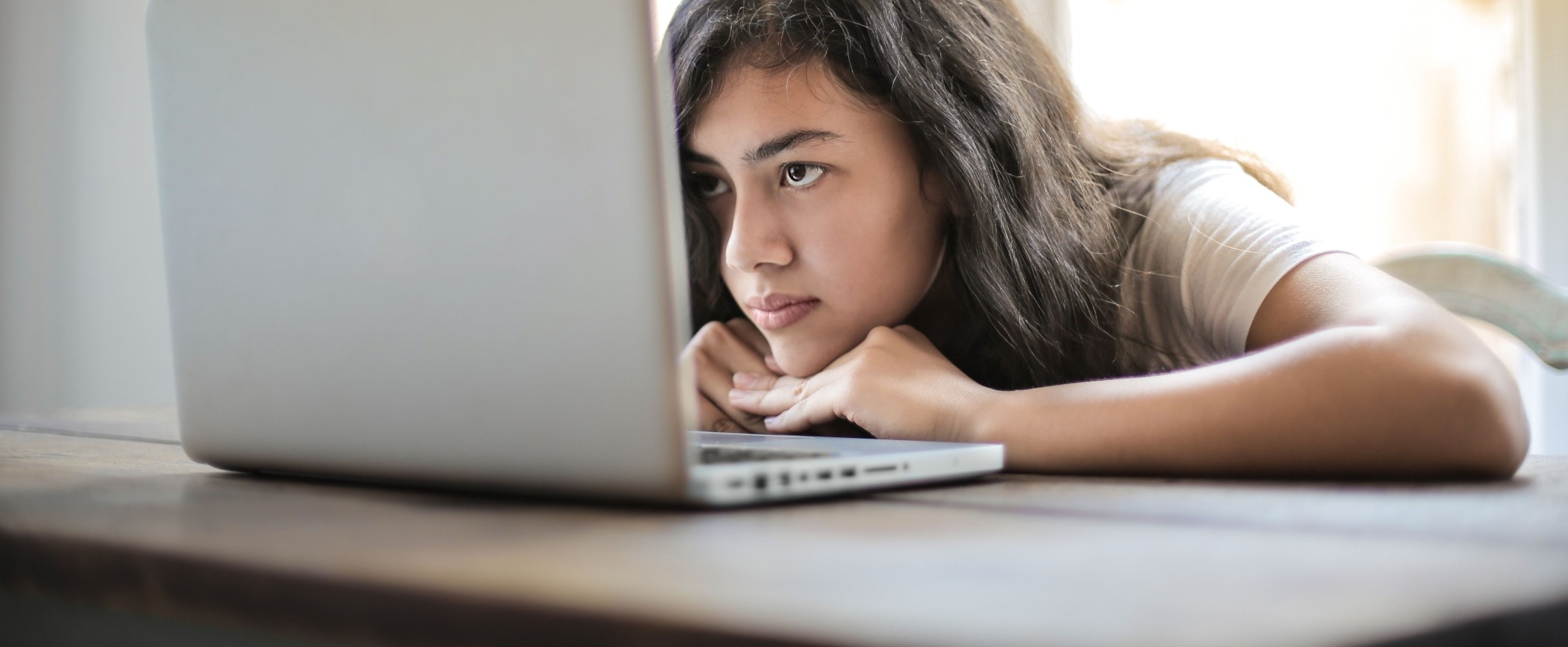 woman staring intently at laptop